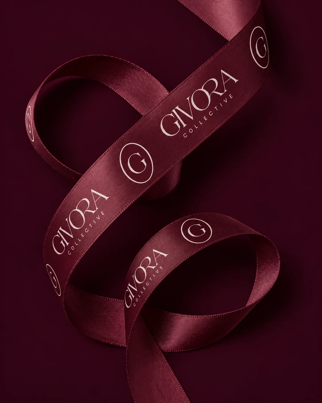 Close view of Burgundy Givora ribbon looped across matching paper