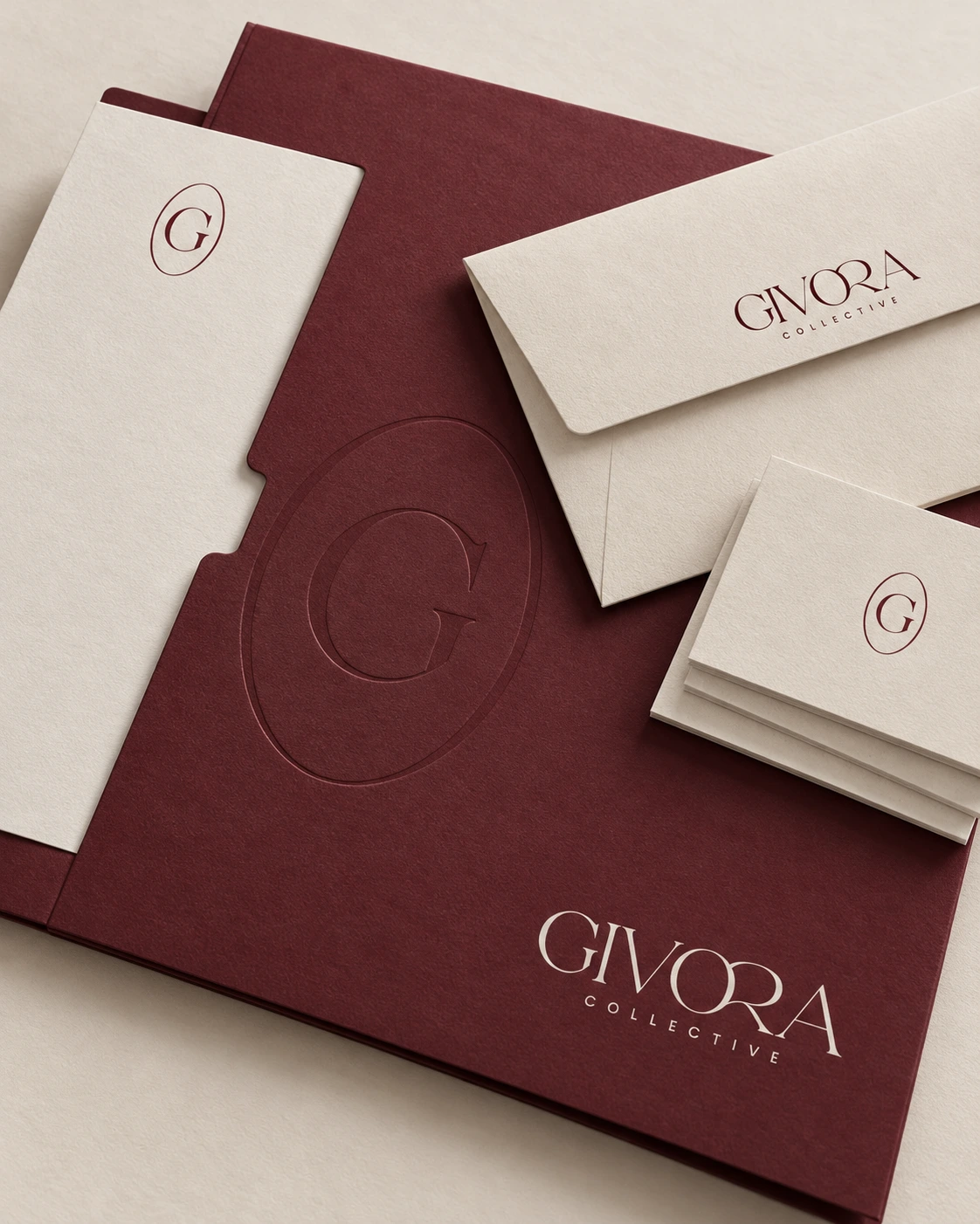Ivory envelopes and cards arranged on Burgundy Givora stationery